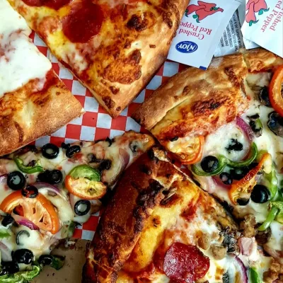 four slices of pepperoni pizza with various toppings